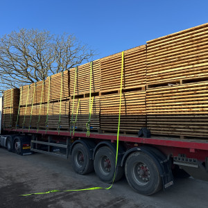 Articulated lorry loaded with bulk fence panels for nationwide wholesale delivery.